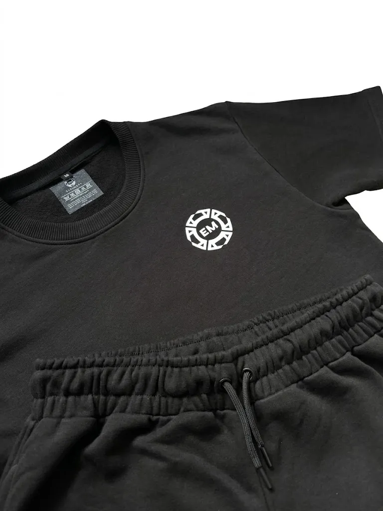 Close-up of the Evermore Club emblem on the black terry fabric