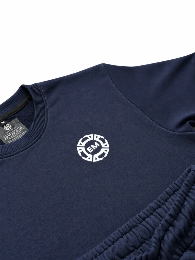 Close-up of the Evermore Club emblem on the navy blue terry fabric